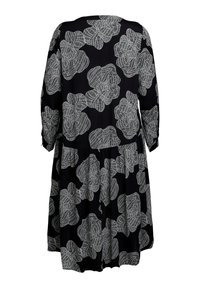 Schwarzes Kleid mit lockerer Passform, das weiß-gestickte Blumenmuster aufweist. Dreiviertelärmel und ein rüschenbesäumter Saum verleihen dem Design das gewisse Etwas.