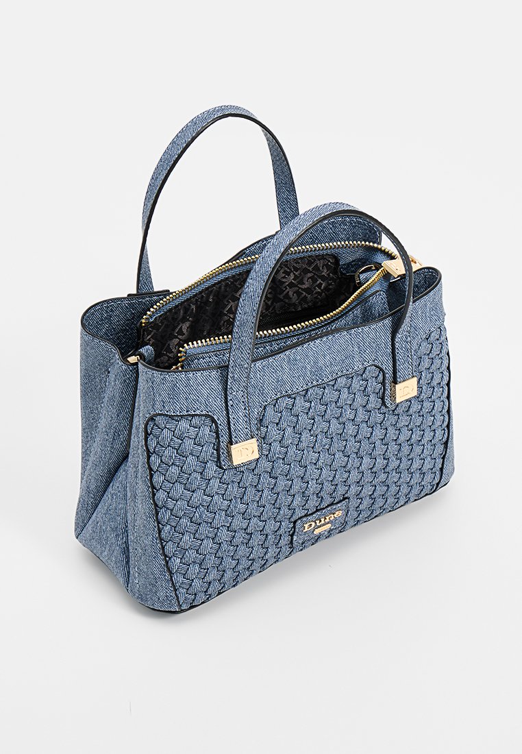 Sac à main tissé bleu avec deux poignées, fermeture éclair dorée et doublure intérieure à motif noir, étiqueté "Dune" à l'avant.