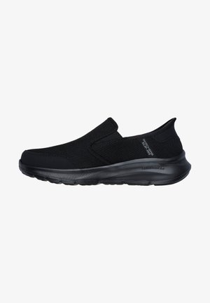 Black slip-on sneaker with mesh upper, elastic side panels, and a cushioned black rubber outsole. Features logo on the heel.