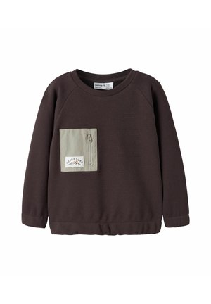 Sweat-shirt marron foncé à manches longues avec une poche poitrine zippée gris clair et un patch "Adventure" montrant des montagnes.