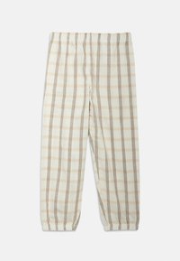 Lightweight, plaid trousers in cream with brown and gray lines. Elastic waistband with tapered cuffs, soft fabric texture, and a relaxed fit.