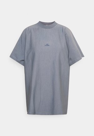 Light blue oversized short-sleeve T-shirt with crew neck and small embroidered text centered on the chest.