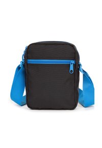 Sort stof crossbody tas med en blå lynlås og justerbar skulderrem. Frontlomme med lynlås, rektangulær form og struktureret overflade.