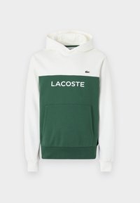 Felpa con cappuccio verde e bianca con tasca a marsupio, con la scritta "LACOSTE" in grassetto sulla parte verde e un piccolo logo sul petto.