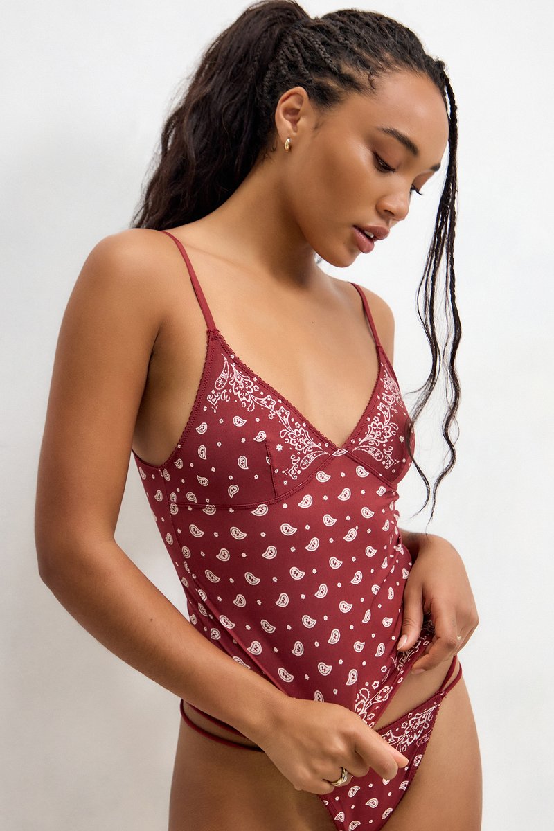 Burgundy lingerie with a floral and paisley print; V-neck design, thin straps, and a fitted cut, featuring subtle lace detailing.