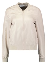 Světle béžová bomber bunda z hladkého syntetického materiálu, s předním zipem, elastickými manžetami a bočními kapsami.