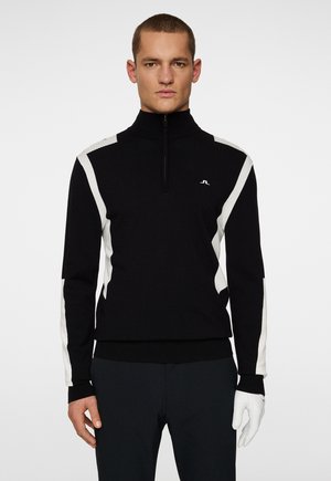 Pullover nero con zip e strisce bianche sui gomiti e sulle spalle. Realizzato in un tessuto testurizzato con un design aderente. Caratterizzato da un logo.