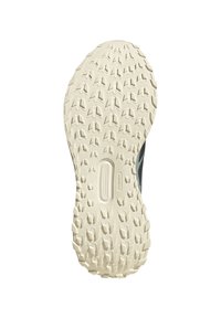 Suela de zapato con superficie texturizada antideslizante y patrones de banda de rodadura pronunciados, principalmente en blanco con detalles sutiles de la marca.