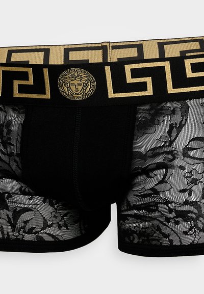Caleçons boxers noirs avec un côté semi-transparent en dentelle à motifs floraux. La ceinture élastique dorée arbore un design de clé grecque et le logo Méduse.