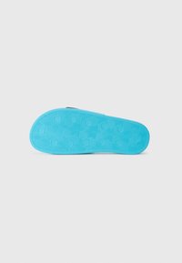 Blue rubber shoe sole with a textured hexagonal pattern and ridges for grip. Smooth finish around the edges, slightly curved shape.