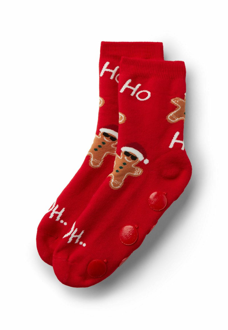 Červené bavlněné ponožky s grafikou perníčkových panáčků v čepicích Santa Clause a nápisem „Ho Ho“. Protiskluzové červené bodky na podrážkách.
