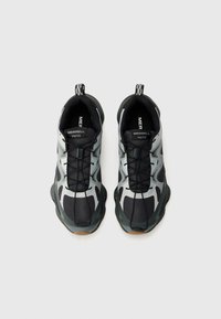 Black and gray athletic shoes with mesh and rubber materials, featuring a textured upper, rubber sole, and black laces.