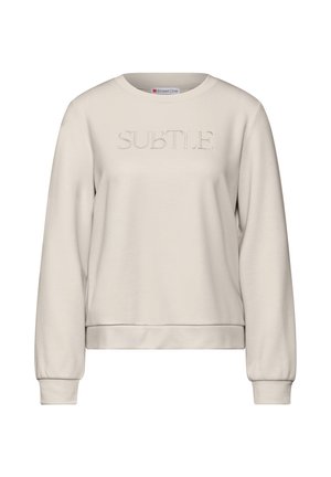 Sweatshirt beige clair en matériau doux, avec un imprimé texturé "SUBTLE" sur le devant, un col rond et des poignets côtelés.