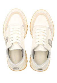 White sneakers with a textured grey accent, cream leather upper, and a heavy rubber sole with orange traction patterns. Laces and side detail present.