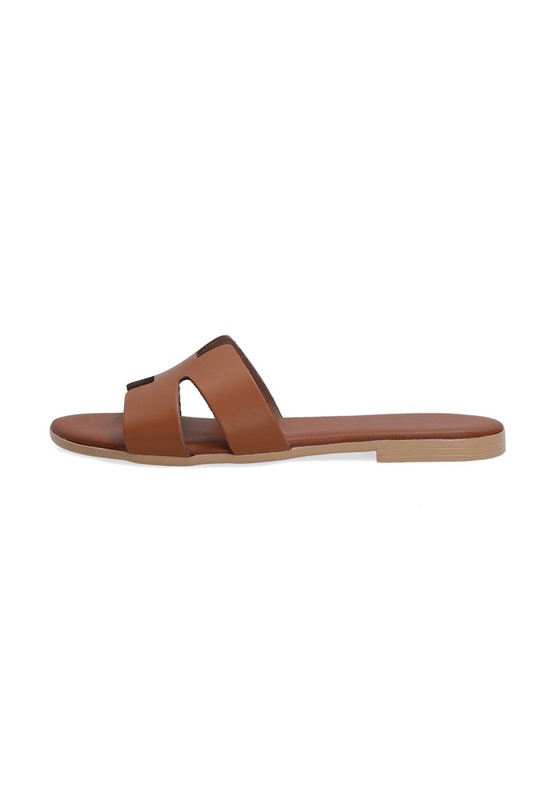 Brown leather slide sandal featuring two wide straps with cutout details, flat sole, and a smooth texture. Modern, minimalist design.