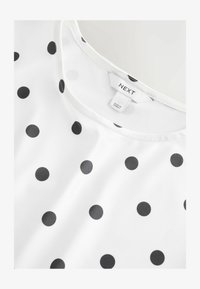 Unselected, black ecru polka dot