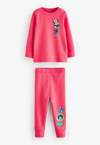 Maglietta a maniche lunghe rosa con grafica di Minnie Mouse e design della gonna verde, abbinata a leggings rosa coordinati con toppe.