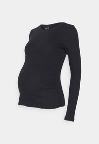 Langärmliges Maternity-Oberteil aus schwarzem Rippstoff mit tailliertem Design, seitlichen Raffungen zur Anpassung an einen wachsenden Bauch und runder Ausschnitt.
