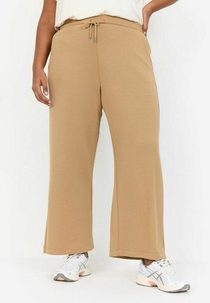 Bežid laiad sweatpants elastse vöökoha ja tõmbluku detailiga. Valmistatud pehmest, tekstuuriga kangast, millel on küljetaskud.