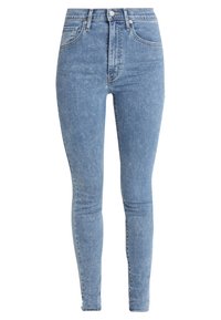Jeans skinny de color azul claro, hechos de denim. Cuentan con una cintura alta, cinco bolsillos, textura desgastada y una cremallera con cierre de botón.