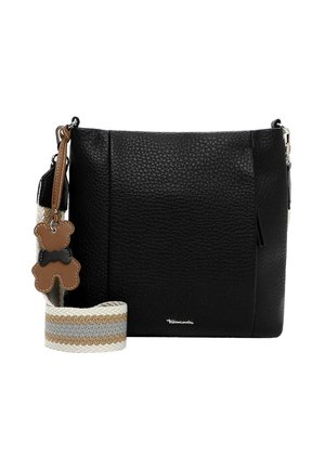 Black textured leather crossbody bag with beige and gray striped fabric strap and brown teddy bear keychain with black bow tie.