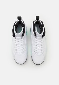 Un paio di sneakers bianche alte con rivestimento interno nero, lacci bianchi e linguette di presa, viste dall'alto su uno sfondo semplice.