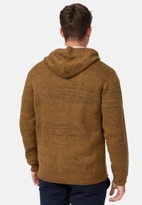 Brown textured hoodie with a relaxed fit, featuring a large hood, ribbed cuffs and hem, showcasing a speckled knit pattern.