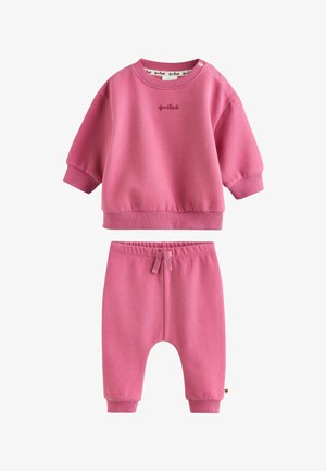 Rosa Sweatshirt für Kleinkinder und passende Hose, elastischer Bund mit Kordelzug, gerippte Bündchen und "smiles" oben mittig eingestickt.
