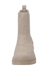 Botines beige de cuero suave con punta redonda, detalles de costura y una lengüeta en la parte trasera. Suela de goma simple.