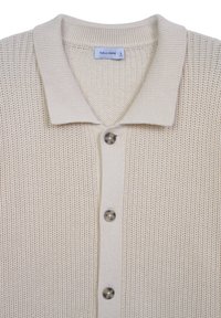 Beige knitted cardigan with a collared neckline, featuring a buttoned front and ribbed texture, made from a soft, breathable fabric.