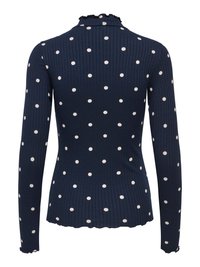 Marineblå ribbet bluse med lange ærmer, hvide polkaprikker, en flæsekant ved halsen og en bølget kant forneden. Glat tekstur med tætsiddende pasform.