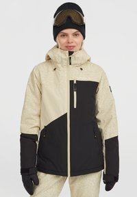 Ski-jack in beige en zwart met een textuurpatroon op de mouwen, ritszakken, verstelbare manchetten en een hoge kraag.