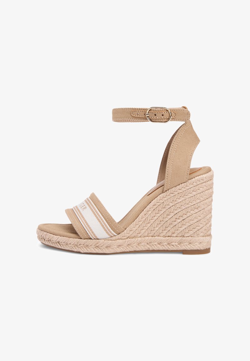 Beige kilehæl sandal med ankelstropp, flettet tauhæl og stoffstropp foran med hvite og lysebrune striper.