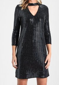 Svart paljettklänning med trekvartslånga ärmar, V-ringning, choker-detalj och en lekfull glans som skapats av vertikala randmönster.
