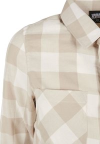 Camicia a scacchi beige e bianca con taschino frontale e colletto, taglia XS, realizzata in tessuto tessuto.
