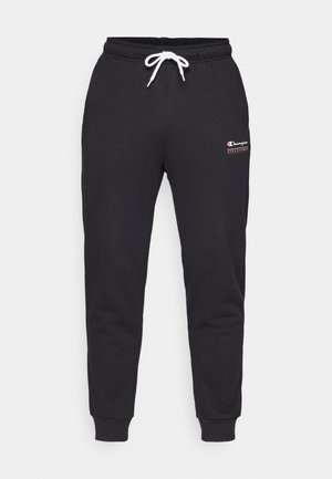 Joggeri gri din bumbac cu talie elastică, șnur alb și manșete ribbate. Prezintă un mic logo roșu și alb pe coapsa stângă.