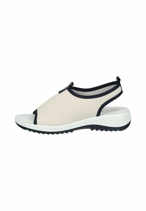 Beige open-toe slingback sandal with black trim, white cushioned sole, and textured black outsole for grip.