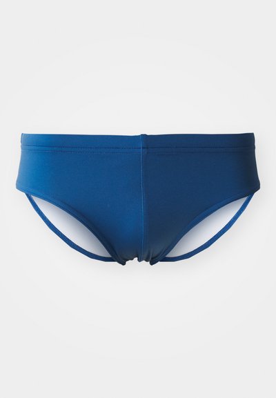 Marineblaue Schwimmhose aus dehnbarem Material, mit einer glatten Oberfläche und verstellbaren seitlichen Trägern für einen sicheren Sitz.