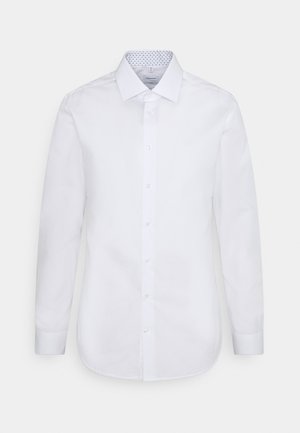 Camicia bianca a maniche lunghe con colletto button-down, tessuto liscio e colletto interno blu a motivi. Caratterizzata da una chiusura frontale con bottoni.