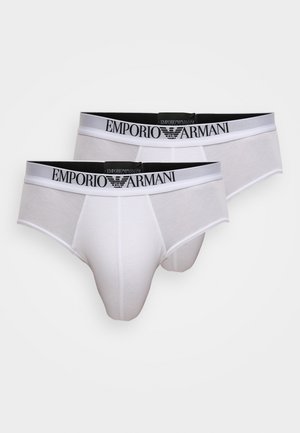 Mutande bianche in cotone con elastico in vita a righe nere e bianche e logo "Emporio Armani". Caratterizzate da una vestibilità aderente e una texture liscia.