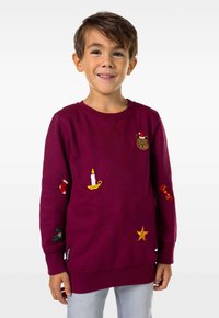 Bordeaux Sweatshirt mit Rundhalsausschnitt, ausgestattet mit gestickten Details: einer Katze, einer Kerze, Strümpfen und einem Stern. Weiches, strukturiertes Material.