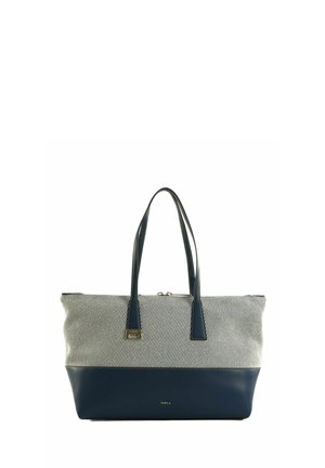 Sac cabas bicolore avec base et poignées en cuir bleu marine, partie supérieure en tissu rayé blanc et gris, et étiquette de marque dorée près de la poignée.