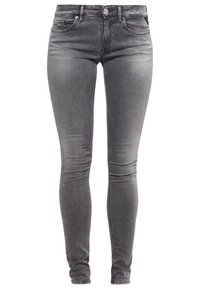 Vaqueros skinny de mezclilla gris con un clásico diseño de cinco bolsillos, que cuentan con herrajes plateados y un ligero desgastado para un aspecto texturizado.