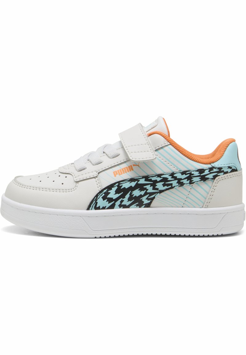 Baskets blanches avec une tige en cuir lisse, un motif zigzag noir et turquoise, des accents orange et une sangle velcro sur les lacets.