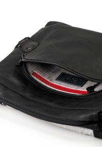 Black leather bag with a zippered closure, featuring a red accent pocket and a plaid lining. Includes a leather tag and smooth texture.