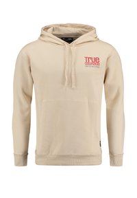 Sudadera beige hecha de material suave, con un bolsillo frontal, capucha con cordón y detalles en texto rojo en el pecho.