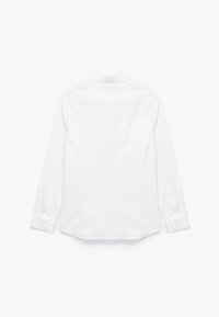 Camisa blanca de manga larga, hecha de una tela suave, con un cuello clásico, puños abotonados y un dobladillo recto sin patrones ni adornos.