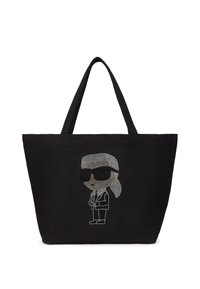 Black tote bag made of fabric, featuring a cartoon design with rhinestones of a figure in sunglasses and suit. Two long handles.