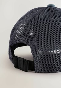 Căciulă de baseball din plasă gri, cu o coroană rotundă, curea ajustabilă neagră și închidere cu capac din plastic la spate. Textură semi-transparentă notabilă.