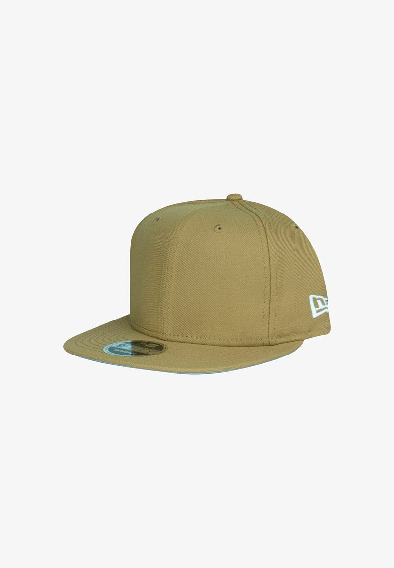 Flat-brimmed beige snapback cap with six ventilation eyelets and a small white embroidered logo on the side.